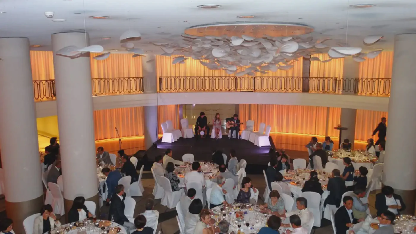 Flamenco performance during a gala dinner event with guests seated around the stage